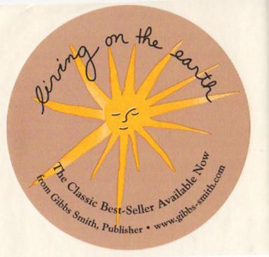 Circular sticker with sun face from the cover of Living on the Earth